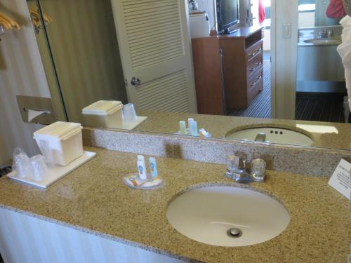 a bathroom counter with a sink and a mirror at Travelodge by Wyndham Palm Springs in Palm Springs