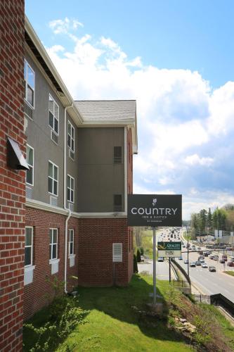 a sign in front of a building with a courtyard at Country Inn & Suites by Radisson, Boone, NC in Boone