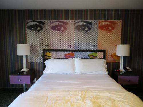 a bedroom with a large bed with two night stands at 7 Springs Inn & Suites in Palm Springs