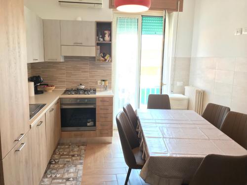 a kitchen with a table with chairs and a dining room at Vista Lago Panorama in Lesina