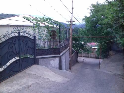 an iron gate with a balcony on a house at Makos Guest House in Kutaisi