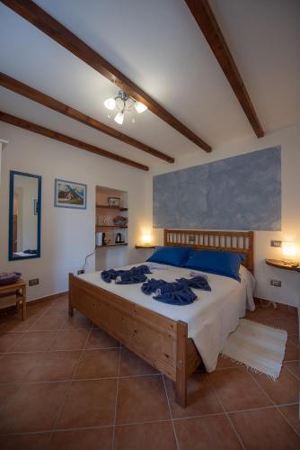 a bedroom with a large bed with blue pillows at Pietra Di Mare in Biassa