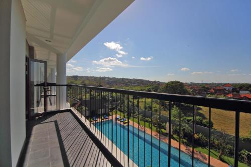 a balcony with a view of a swimming pool at Hotel Santika Siligita Nusa Dua in Nusa Dua