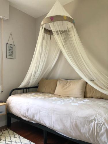 a bed with a canopy in a bedroom at La Toja. Urb. Rueiros. in Isla de la Toja