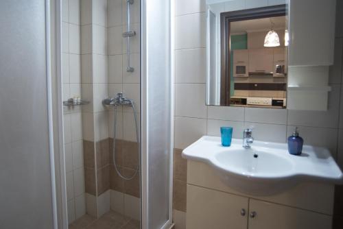 a bathroom with a sink and a shower at Maria's Rose Garden in Lefkada Town