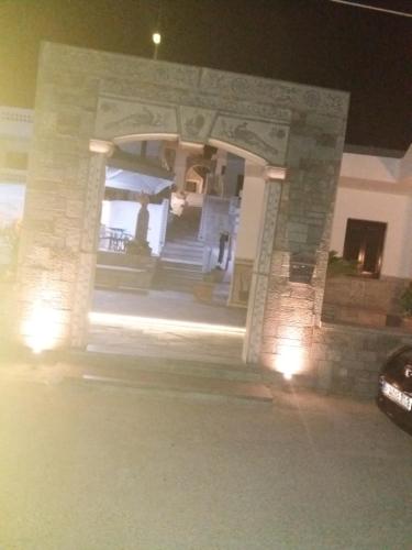 a house at night with a car parked in front at Manos Apartments in Agios Nikolaos