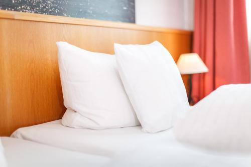 Кровать или кровати в номере AKZENT Hotel Sternen