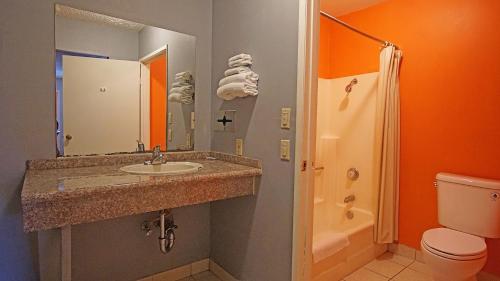 a bathroom with a sink and a toilet and a shower at Los Angeles Inn & Suites - LAX in Los Angeles