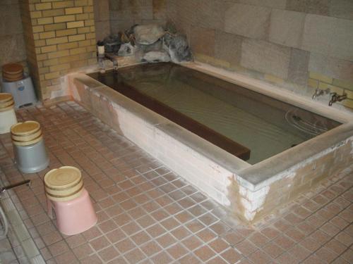 a bath tub in a bathroom being remodeled at Hakuba Hotel Hana-no-Sato in Hakuba
