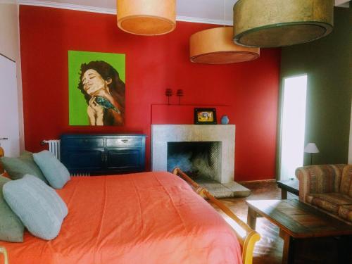 a red bedroom with a bed and a fireplace at Casco El Trapiche in Godoy Cruz