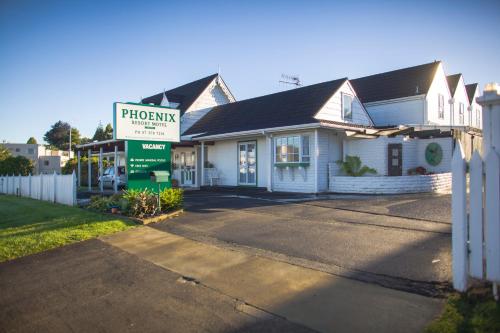 a house with a pharmacy sign in front of it at Phoenix Thermal Resort - Taupo in Taupo