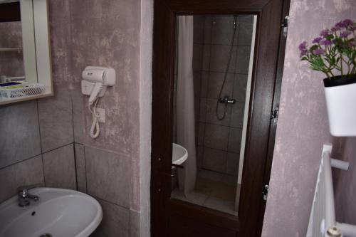 a bathroom with a sink and a toilet and a shower at Vila Tudor Mamaia Nord in Mamaia Nord