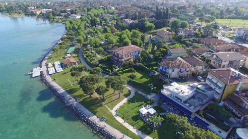 an aerial view of a house next to the water at Hotel Ca' Serena in Sirmione