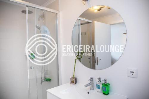 a bathroom with a sink and a mirror at Ericeira Lounge Seaside Apartment in Ericeira