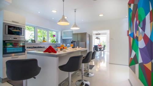 a kitchen with a counter and stools in a room at Organic Gardens Villa in Crikvenica