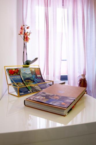 a group of books sitting on top of a table at Borghese Apartment in Locarno
