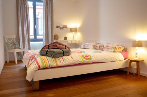 a bedroom with a bed with a colorful comforter at Borghese Apartment in Locarno