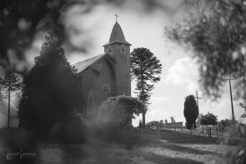 a black and white photo of a church with a steeple at Hotel Casa de la Oma in Frutillar