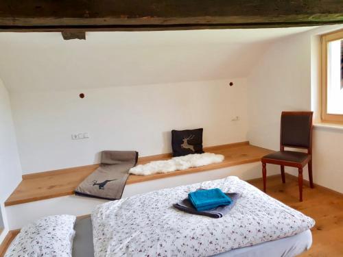 ein Schlafzimmer mit einem Bett, einem Stuhl und einem Schreibtisch in der Unterkunft Echtes Schwarzwaldhaus - Traditionell & Modern in Bernau im Schwarzwald