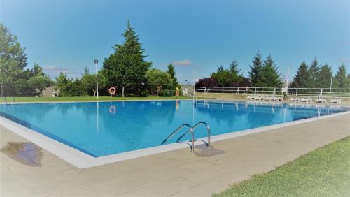 a large swimming pool with blue water at Alojamento Rural de Vales in Vales