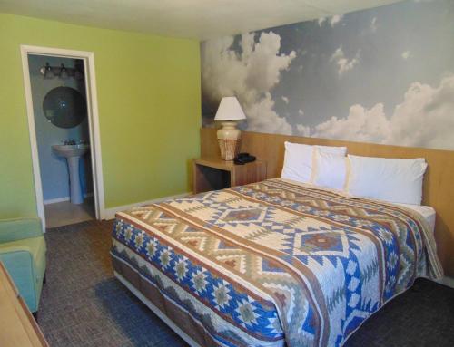 a hotel room with a bed and a painting on the wall at Bryce Canyon Resort in Bryce Canyon