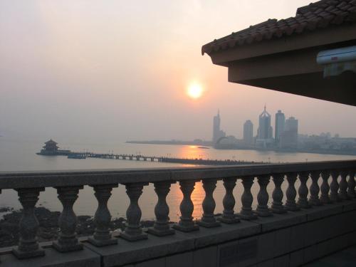 a view of the city from a balcony of a building at Qingdao Oceanwide Elite Hotel in Qingdao