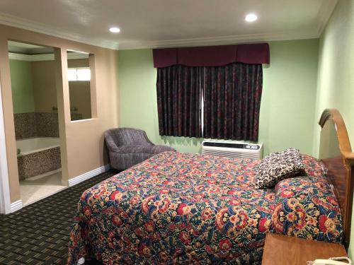 Cette chambre comprend un lit et une salle de bains. dans l'établissement American Inn & Suites LAX Airport, à Inglewood