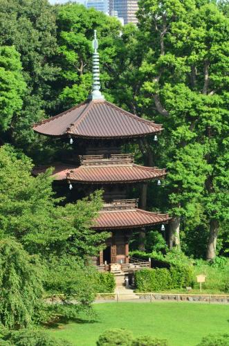 a pagoda with a cross on top of it in a park at Hotel Chinzanso Tokyo in Tokyo
