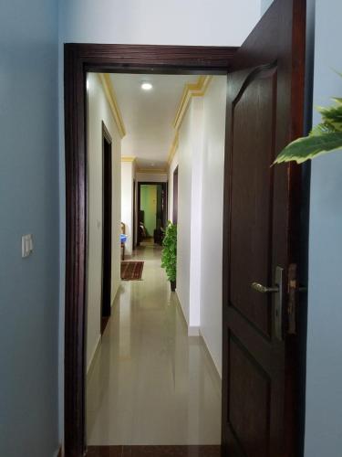 a hallway with a door leading to a room at Stanley Bridge Apartment in Alexandria