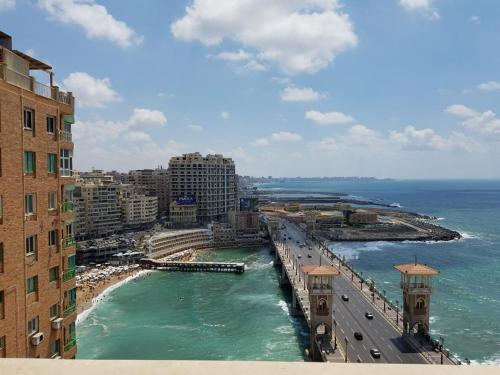 a view of a city with the ocean and buildings at Stanley Bridge Apartment in Alexandria