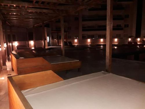 a room with tables and lights in a building at Apto Le Bon Vivant Vista Mar in Arraial do Cabo