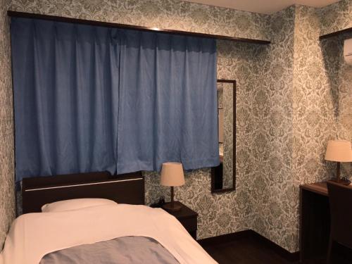 Postel nebo postele na pokoji v ubytování Hatoya Hotel