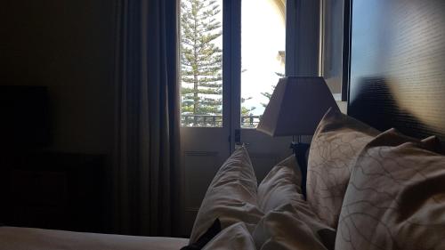 a bedroom with a bed with a window at Largs Pier Hotel in Adelaide