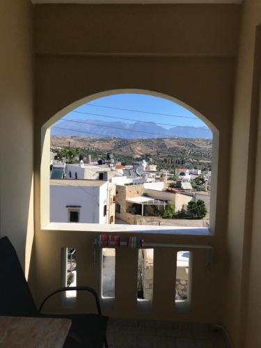 a window in a room with a view of a city at Pension Nikos in Pitsidia