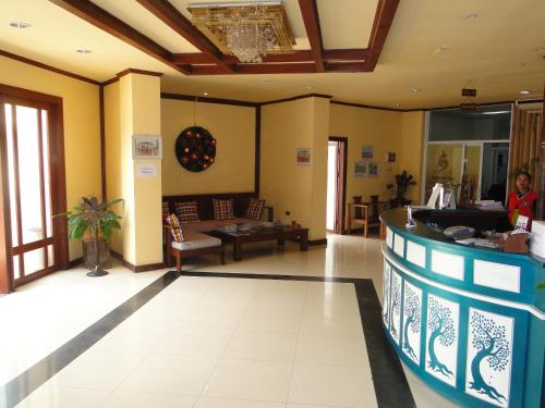 a lobby with a bar and a living room at Charming Lao Hotel in Ban Chéng