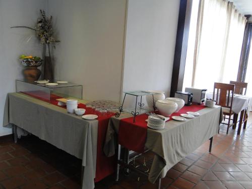 a table with plates and bowls on top of it at Charming Lao Hotel in Ban Chéng