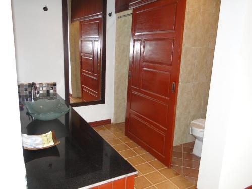 a bathroom with a sink and a toilet and a mirror at Charming Lao Hotel in Ban Chéng