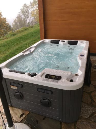 a hot tub sitting on top of a patio at Almchalet Orter in Deutschberg