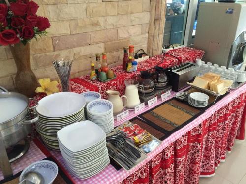 a table with plates and dishes on top of it at Yuwadee Resort in Chalong 
