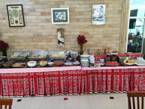 a buffet of food on a table with red table cloth at Yuwadee Resort in Chalong 