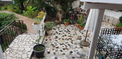 a garden with potted plants on a patio at Rooms & Apartments Semić in Opatija