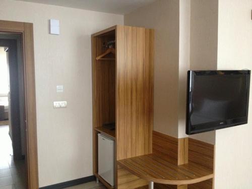 a room with a tv and a book shelf at Buyuk Hotel in Kayseri