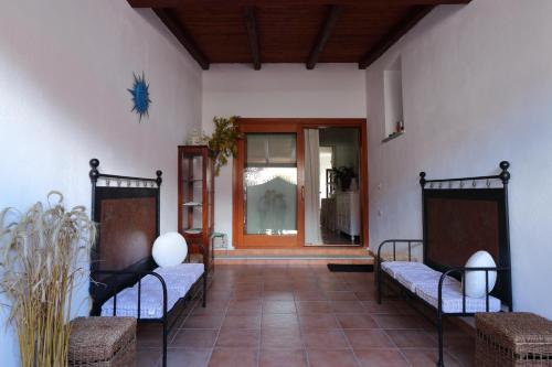 a hallway with two benches and a door to a room at Guest House Li Minnanni in Olbia