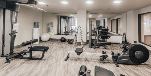 a gym with weights and cardio equipment in a room at Exe Lev in Ljubljana