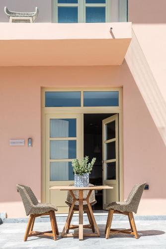 a table and two chairs in front of a building at Avra Apartments Kolymbari Harbour in Kolymvari