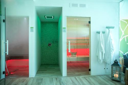 a bathroom with a glass door leading to a shower at Energy Hotel in Calceranica al Lago