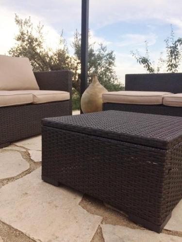 two wicker chairs and a couch and a vase at B&B and Wellness Il Pomario di Montepiglio Resort Naturista in Amelia