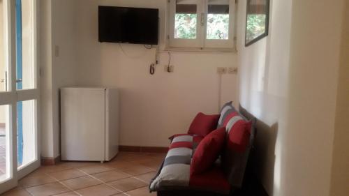 a living room with a couch and a television at Mirto E Mare in Muravera
