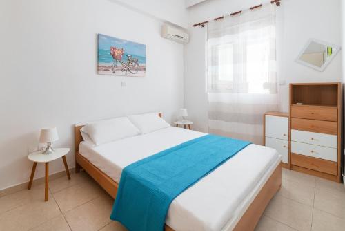 a bedroom with a bed and a dresser in it at Maximos Sea & The City in Rhodes Town