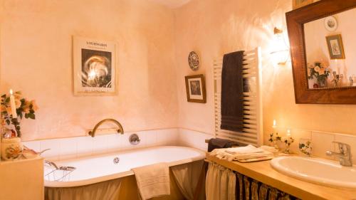 ein Badezimmer mit Badewanne und Waschbecken in der Unterkunft La Cordière in Lourmarin